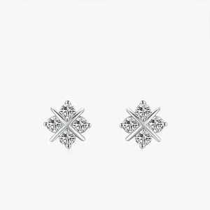 Pair of silver earrings with diamond-like stones on a white background