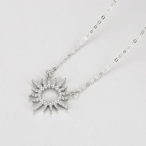 Sunrise Splendor Pendant - TM & CO. JEWELS - Silver sun-shaped pendant necklace on a light gray background
