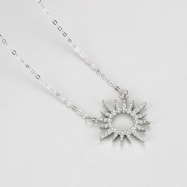Silver necklace with a star-shaped pendant on a light gray background