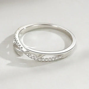Sterling silver ring with thorn branch design and pavé cubic zirconia on a light background
