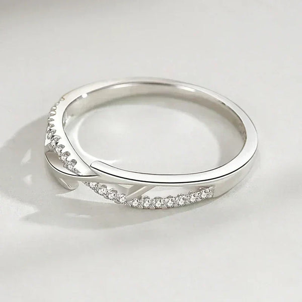 Sterling silver ring with thorn branch design and pavé cubic zirconia on a light background
