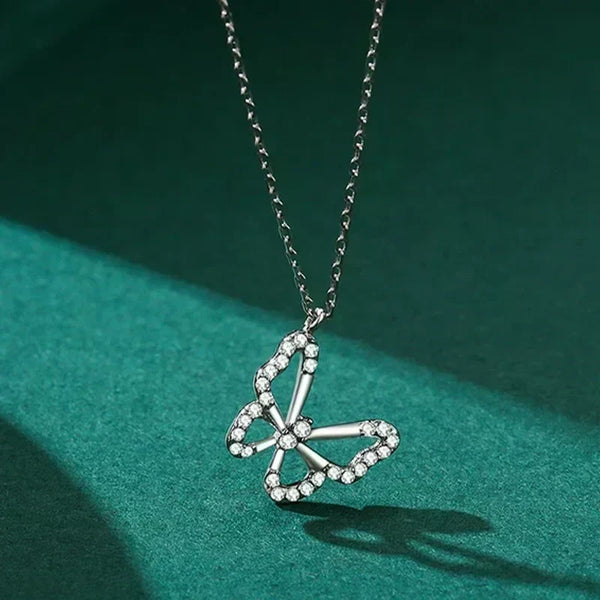 Butterfly Elegance Necklace - TM & Co. Jewels-Silver necklace with a butterfly pendant on a green background.