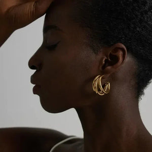 Woman wearing layered gold hoop earrings, elegant jewelry for women
