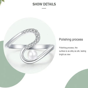Silver ring with a pearl on a white background, highlighting the polishing process.