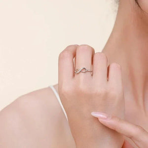 Woman wearing a 925 silver infinity ring with subtle gemstone accents, elegant jewelry