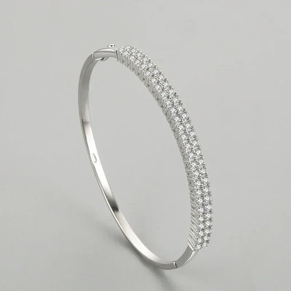 925 sterling silver bangle with triple row pavé cubic zirconia on a plain background
