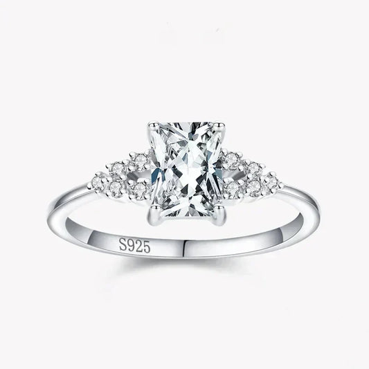 925 silver ring with rectangular clear center stone and small round gemstones on band