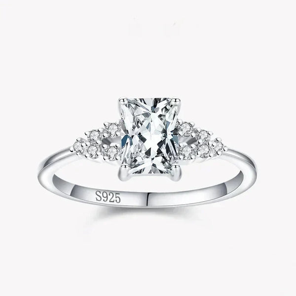 925 silver ring with rectangular clear center stone and small round gemstones on band