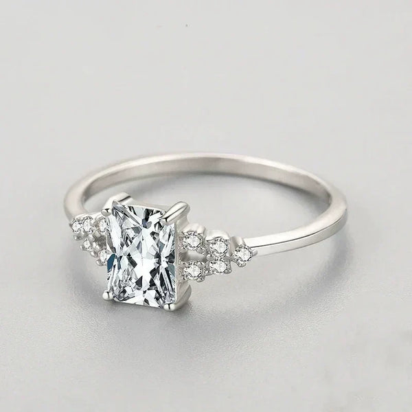 Sterling silver ring with rectangular clear stone and small accent crystals on band