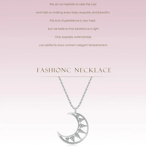 Silver necklace with a crescent moon pendant on a pink background