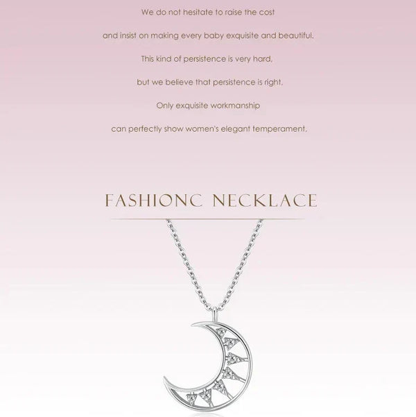 Silver necklace with a crescent moon pendant on a pink background