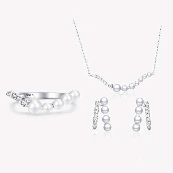 925 silver jewelry set with pearl accents, including a necklace, ring, and earrings on white background