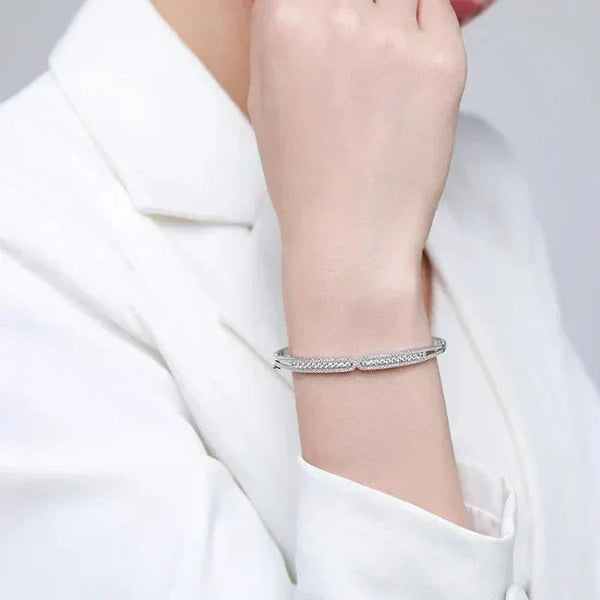 Silver bracelet on a person's wrist with a plain background-Ava Heart Bands - TM & CO. JEWELS 