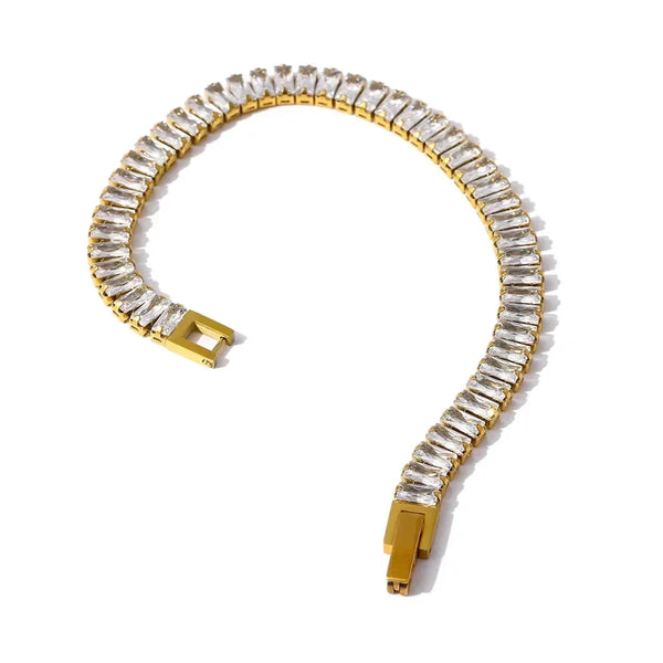 Gold bracelet with clear gemstones on a white background