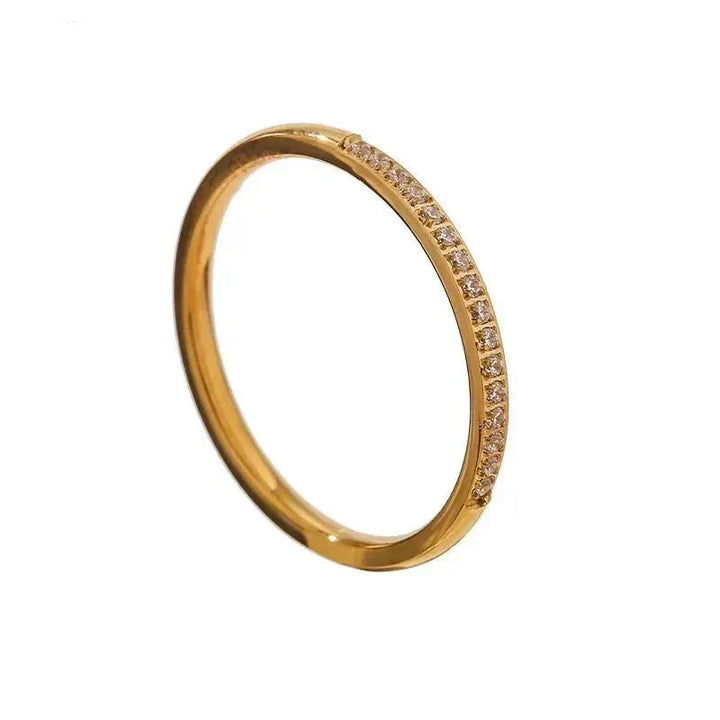 Gold ring with small diamonds on a white background