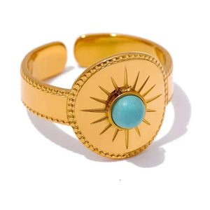 Gold-plated open cuff ring with sunburst design and round turquoise gemstone center