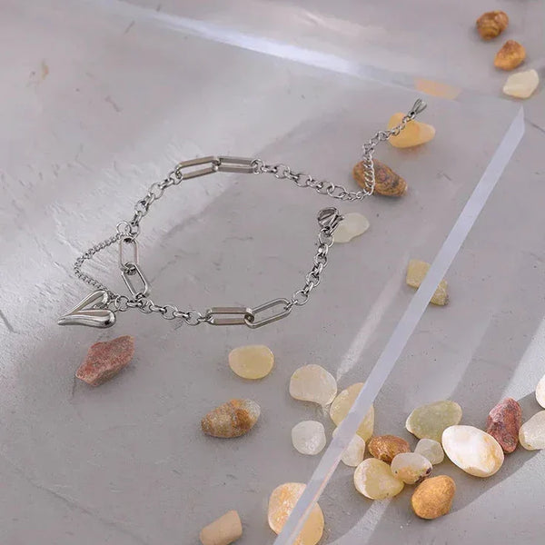 Steel chain bracelet with heart charm and modern rectangular links