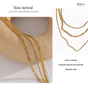 Gold chain necklaces on a textured surface with 'NEW++' branding.