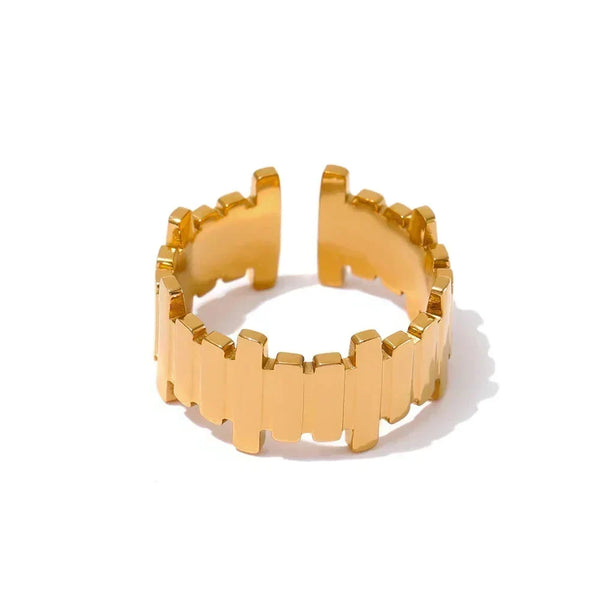 Gold ring with geometric design on a white background