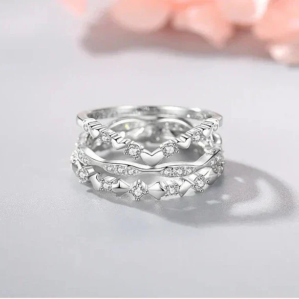 925 silver heart-shaped ring with clear gemstones on white background