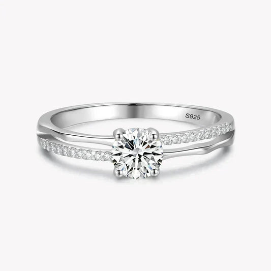 925 silver ring with round solitaire center and pavé set stones on split band.