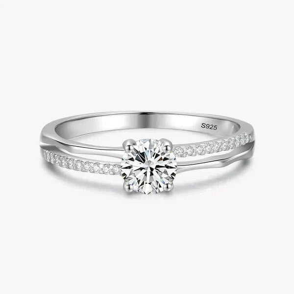 925 silver ring with round solitaire center and pavé set stones on split band.