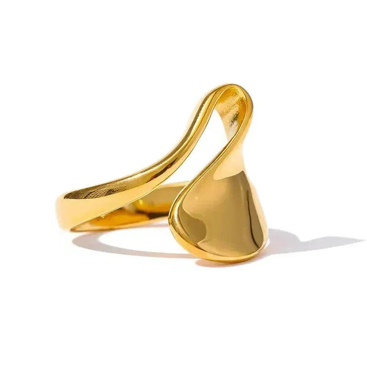 Gold ring with a modern design on a white background