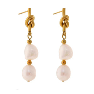 Gold and pearl earrings on a white background.