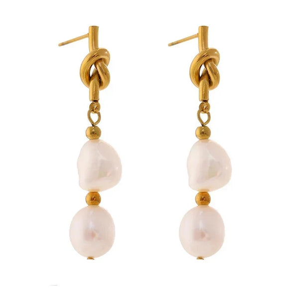 Gold and pearl earrings on a white background.