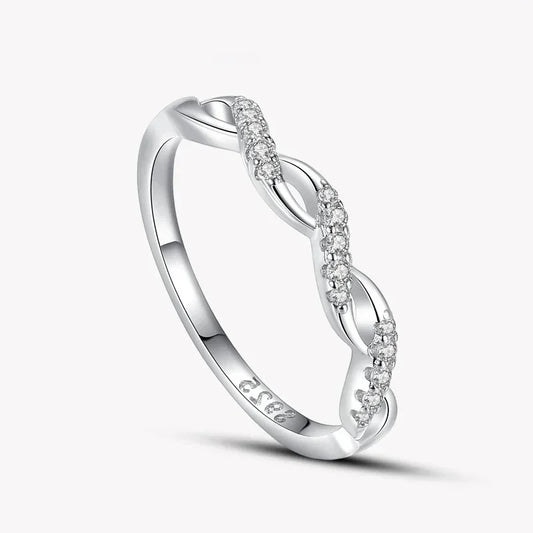 925 silver twisted band ring with sparkling clear stones on white background
