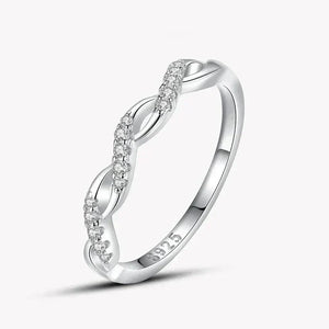 925 silver twisted band ring with sparkling clear stones on white background