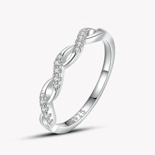 925 silver twisted band ring with sparkling clear stones on white background