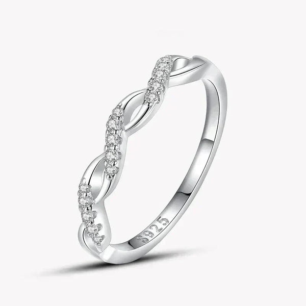 925 silver twisted band ring with sparkling clear stones on white background