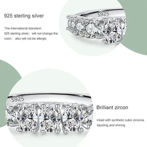Silver earrings with zirconias on a white background