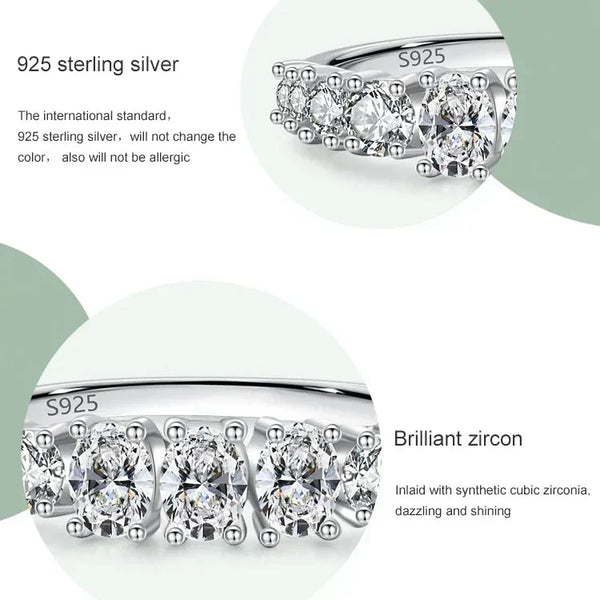 Silver earrings with zirconias on a white background