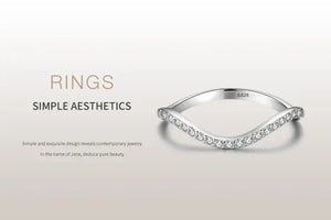 Sterling silver minimalist ring with curved design and embedded cubic zirconia stones