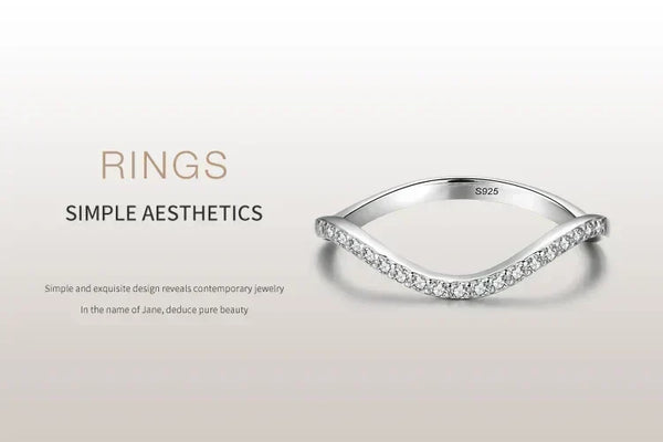 Sterling silver minimalist ring with curved design and embedded cubic zirconia stones