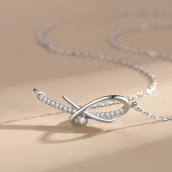 Silver necklace with a fish-shaped pendant on a beige background-Sleek Geometry Pendant - TM & Co. Jewels.