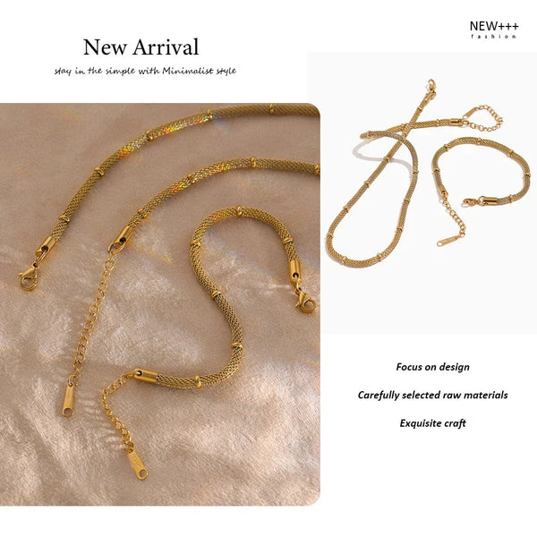 Gold necklaces on a textured surface with 'NEW++' branding.