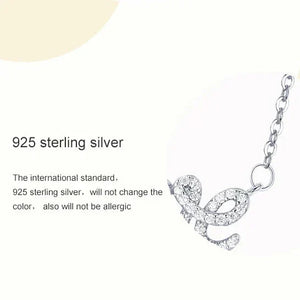 Silver necklace with 'love' pendant on a white background