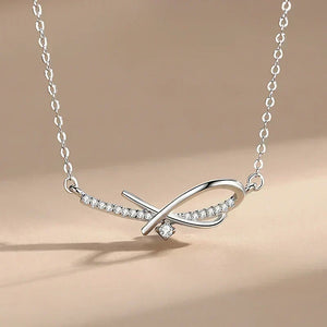 Sleek Geometry Pendant - TM & Co. Jewels-Silver necklace with diamond accents on a beige background.