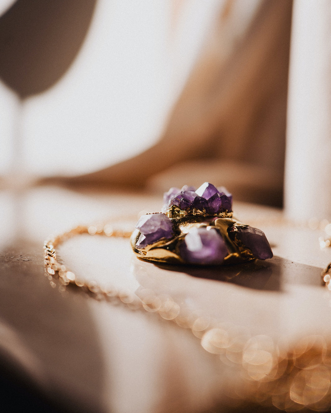 Necklace with purple gemstones on a soft, blurred background