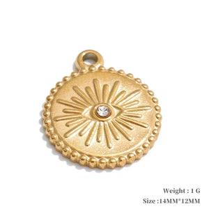 Gold pendant with eye design on a white background