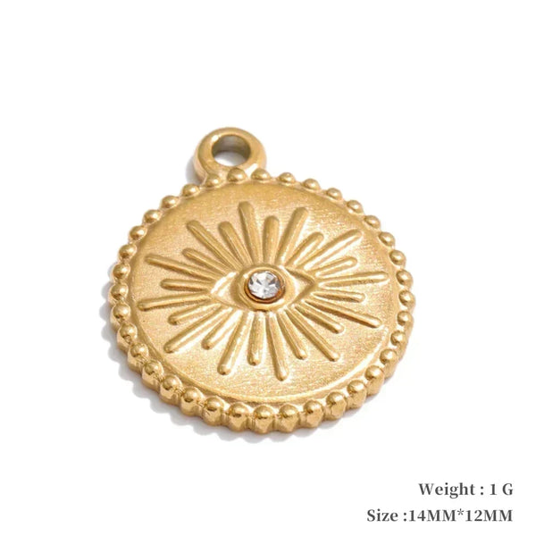 Gold pendant with eye design on a white background