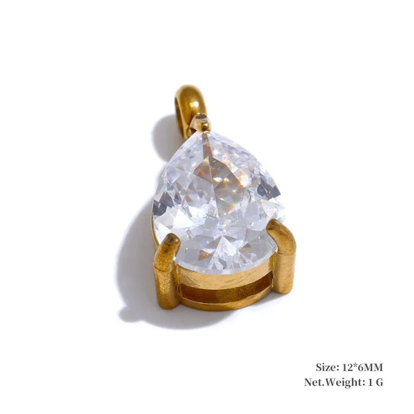 Gold pendant with a large clear gemstone on a white background