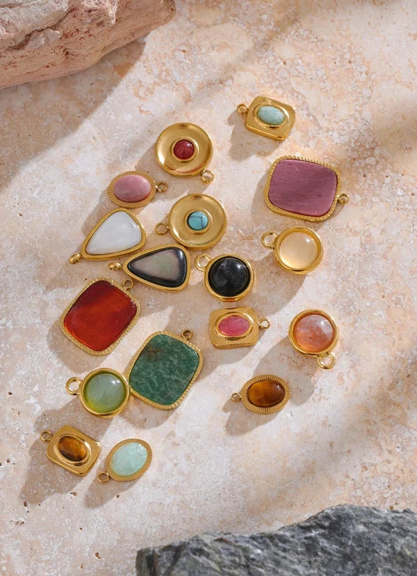 Gold jewelry with colorful gemstones on a textured stone surface, labeled 'Fashion Accessories'.