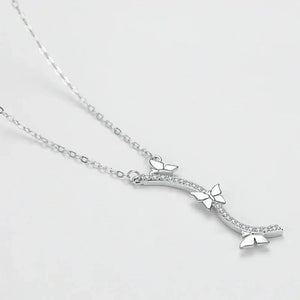 Wings of Nature Necklace - TM & Co. Jewels-Silver necklace with a bow-shaped pendant on a light gray background.