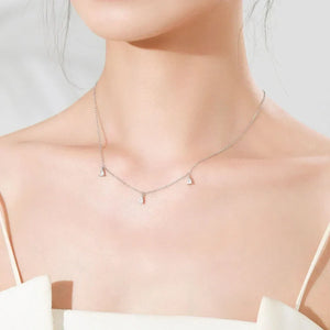 Necklace with small pendants on a mannequin with a plain background
