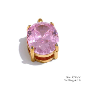 Pink gemstone ring with gold setting on a white background