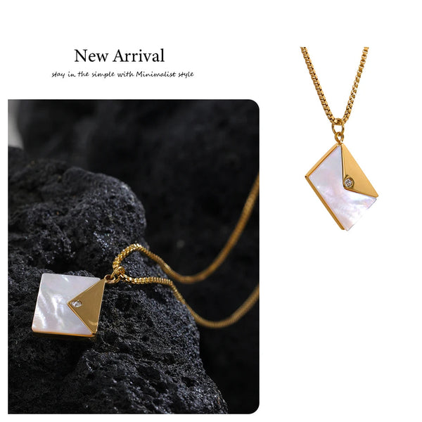 Gold necklace with a geometric pendant on a dark background